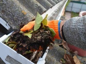 person providing gutter cleaning service