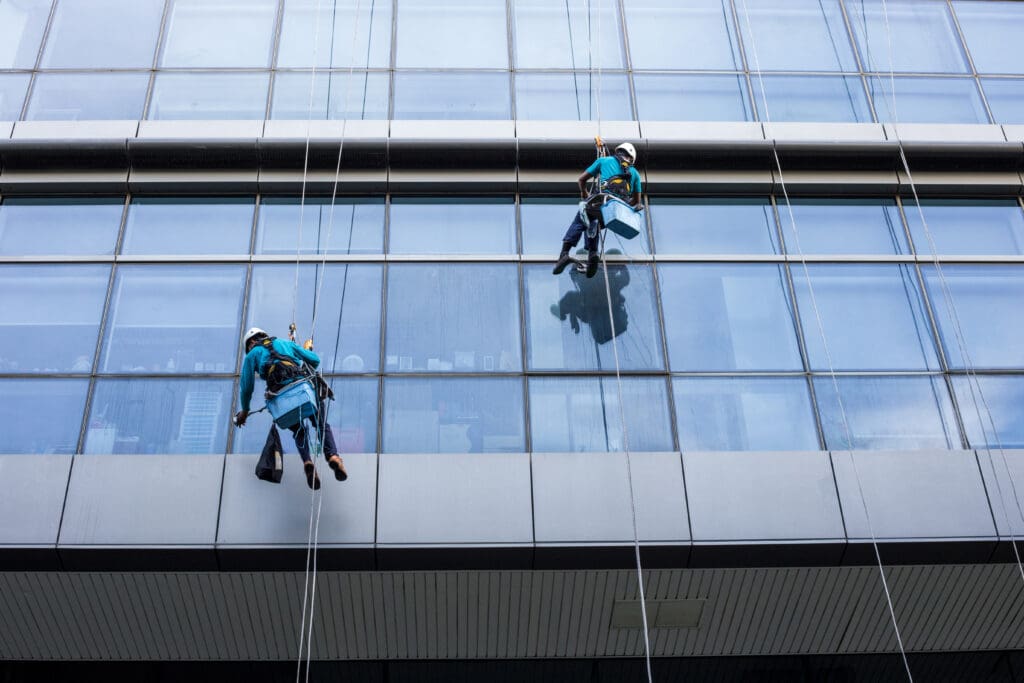 window washing professionals doing work on a commercial building