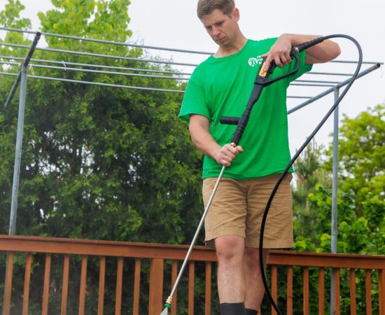 a man power washing a deck