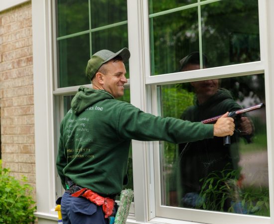 man washing a double hung window