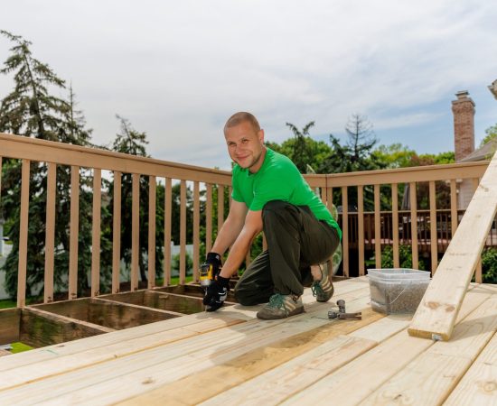 deck restoration technician smiling at the camera