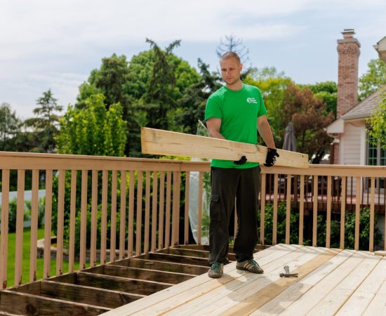 A man transporting lumber for deck construction.